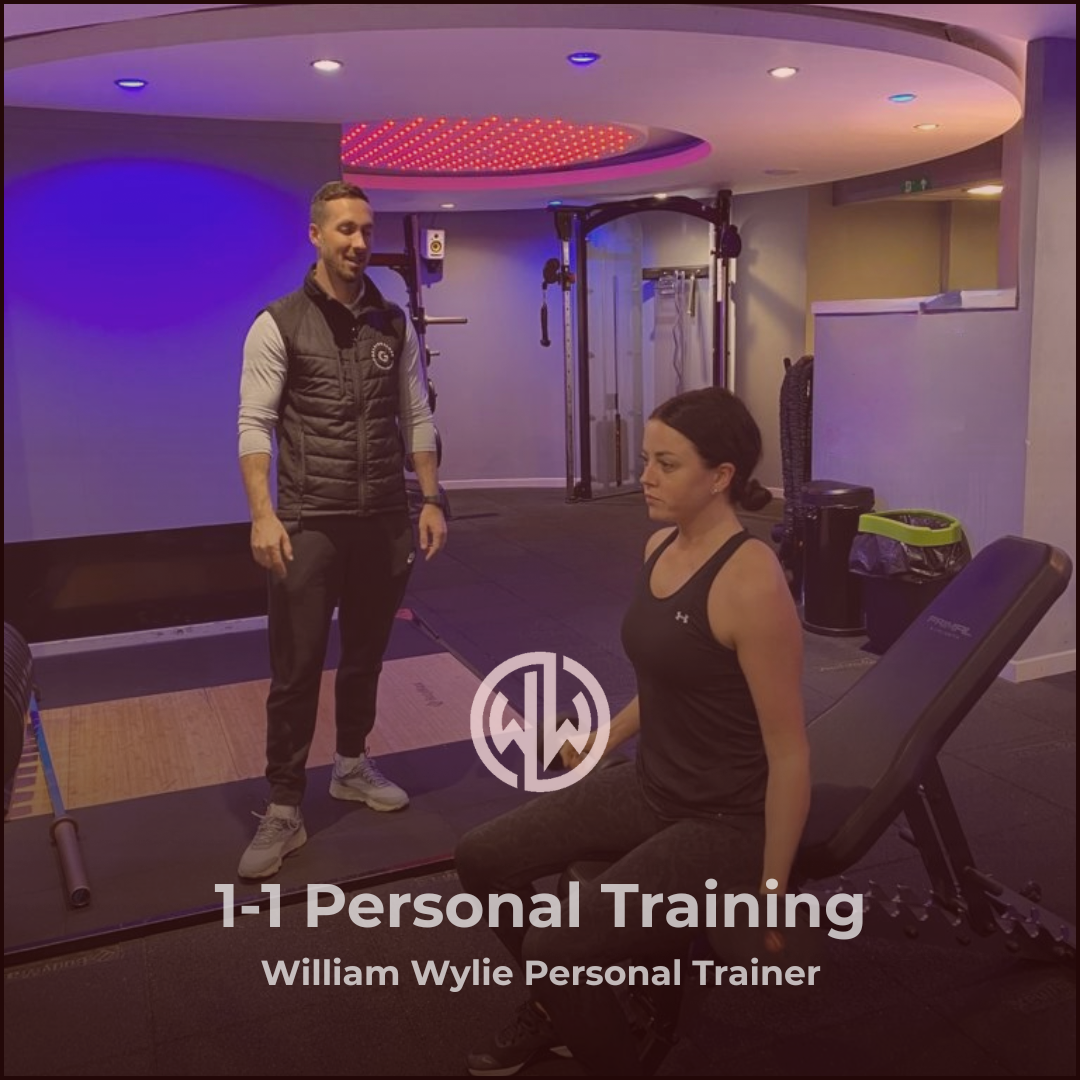 Personal trainer and client in a gym setting with 'William Wylie Personal Trainer' branding.